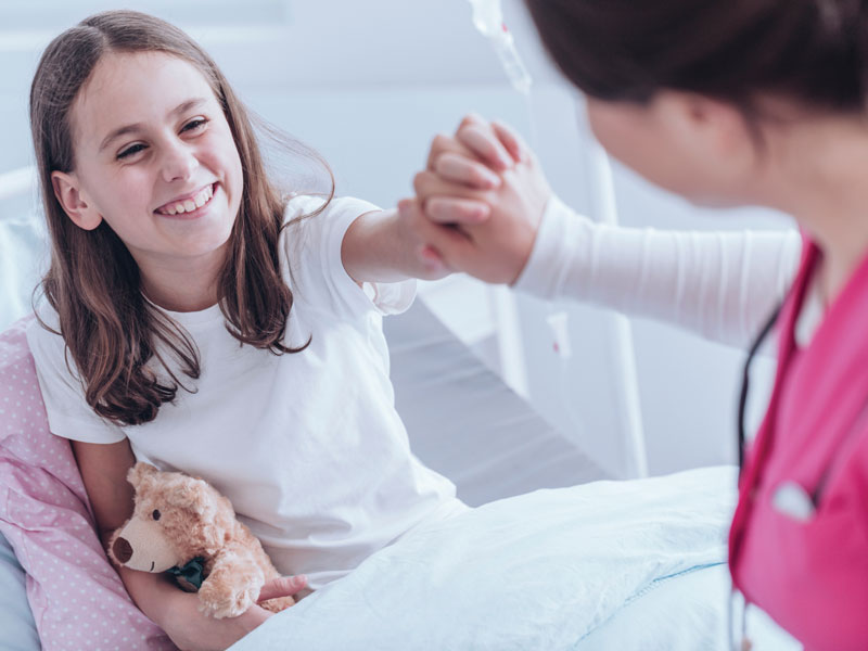 Young child teaming up with a nurse for cancer prevention