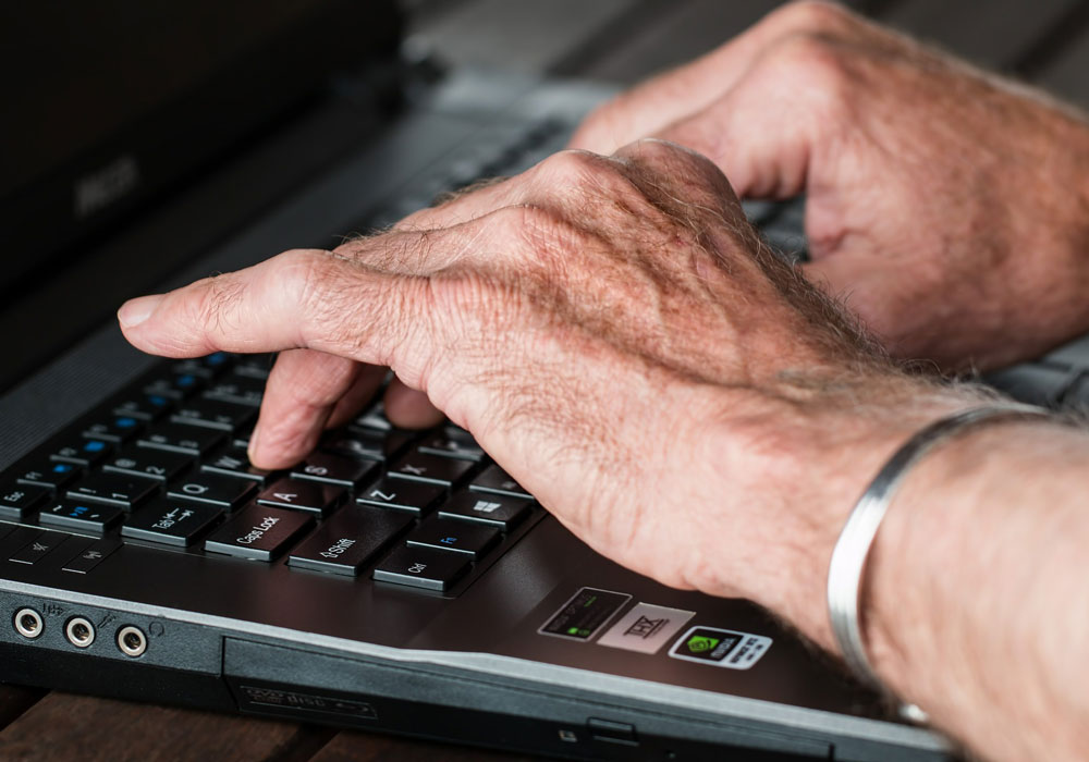 hands typing on a keyboard