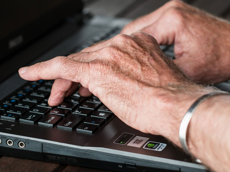 hands typing on a keyboard