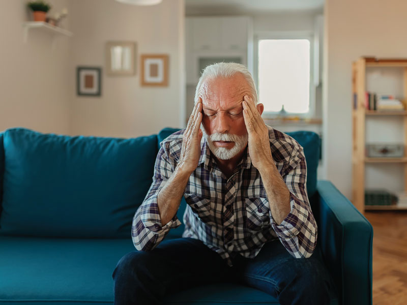 male patient holding his head in his hands