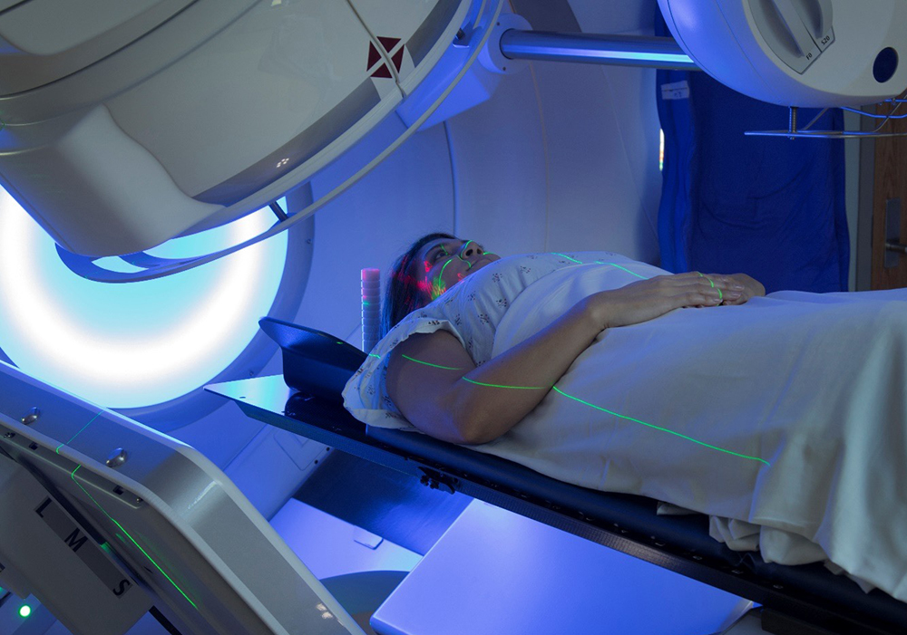 patient lying on back on radiation table for cancer therapy