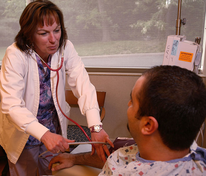 Oncology nurse and cancer patient consultation